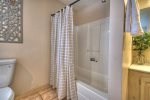 Master bathroom with a tub shower combo and jetted tub 